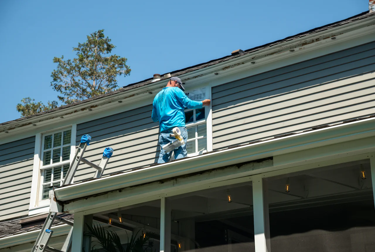 Kincaide crew working on siding from a ladder